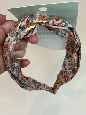 Cute pink floral twist-knot fashion headband featuring gold foil accent details